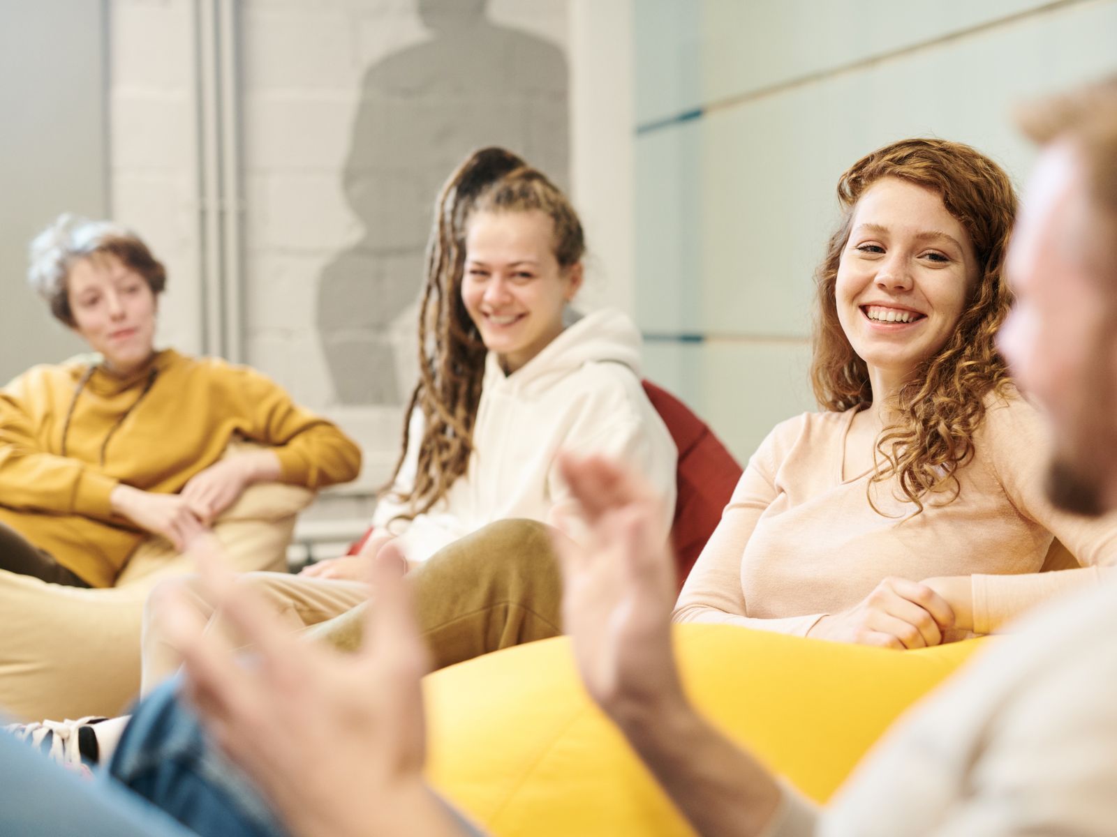 A group of adults sitting together, talking and laughing