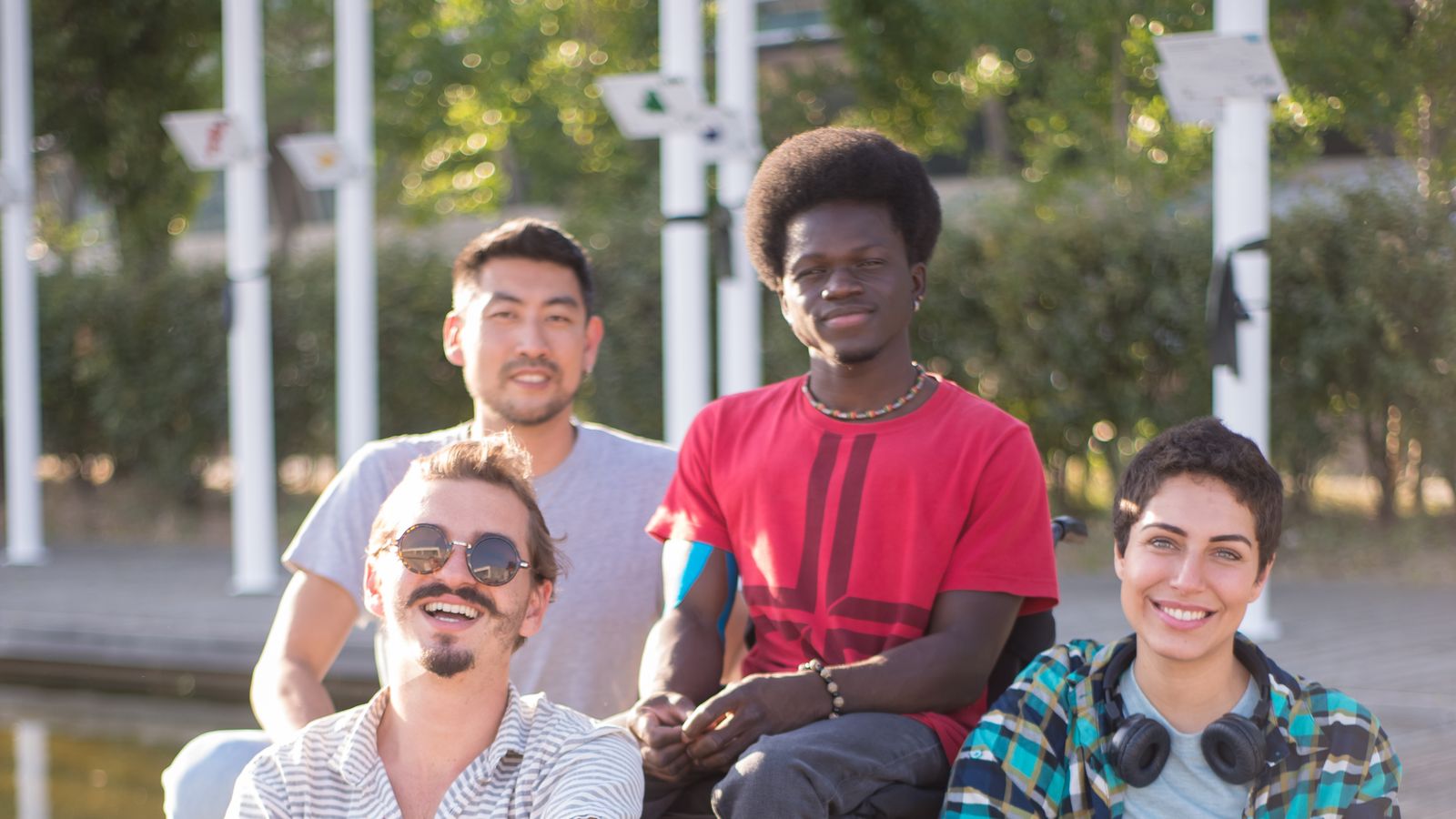 A group of friends sitting together outdoors on a sunny day