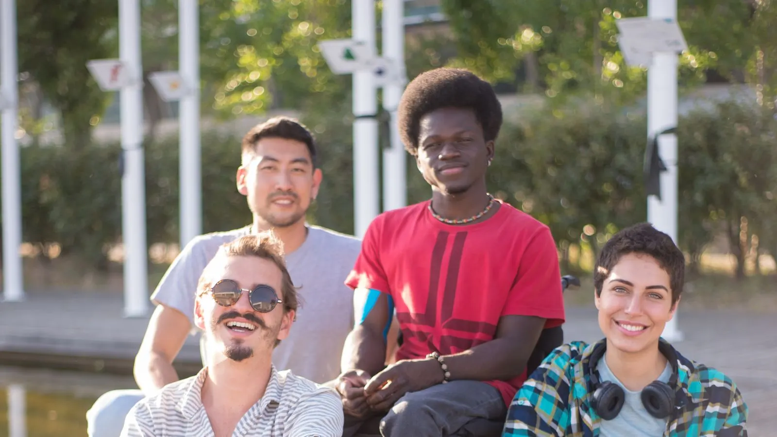 A group of friends sitting together outdoors on a sunny day